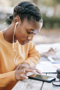 image of young girl looking through her smartphone