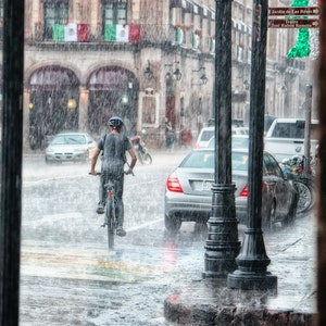 gril riding bicycles in the rain
